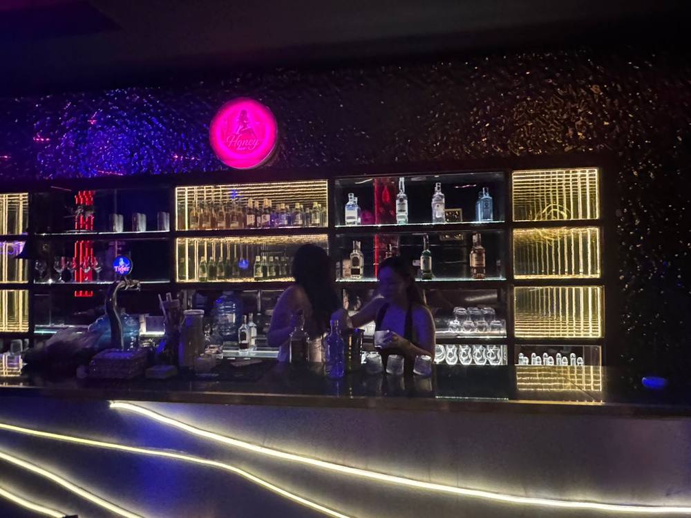 Honey Bar neon logo above the bar