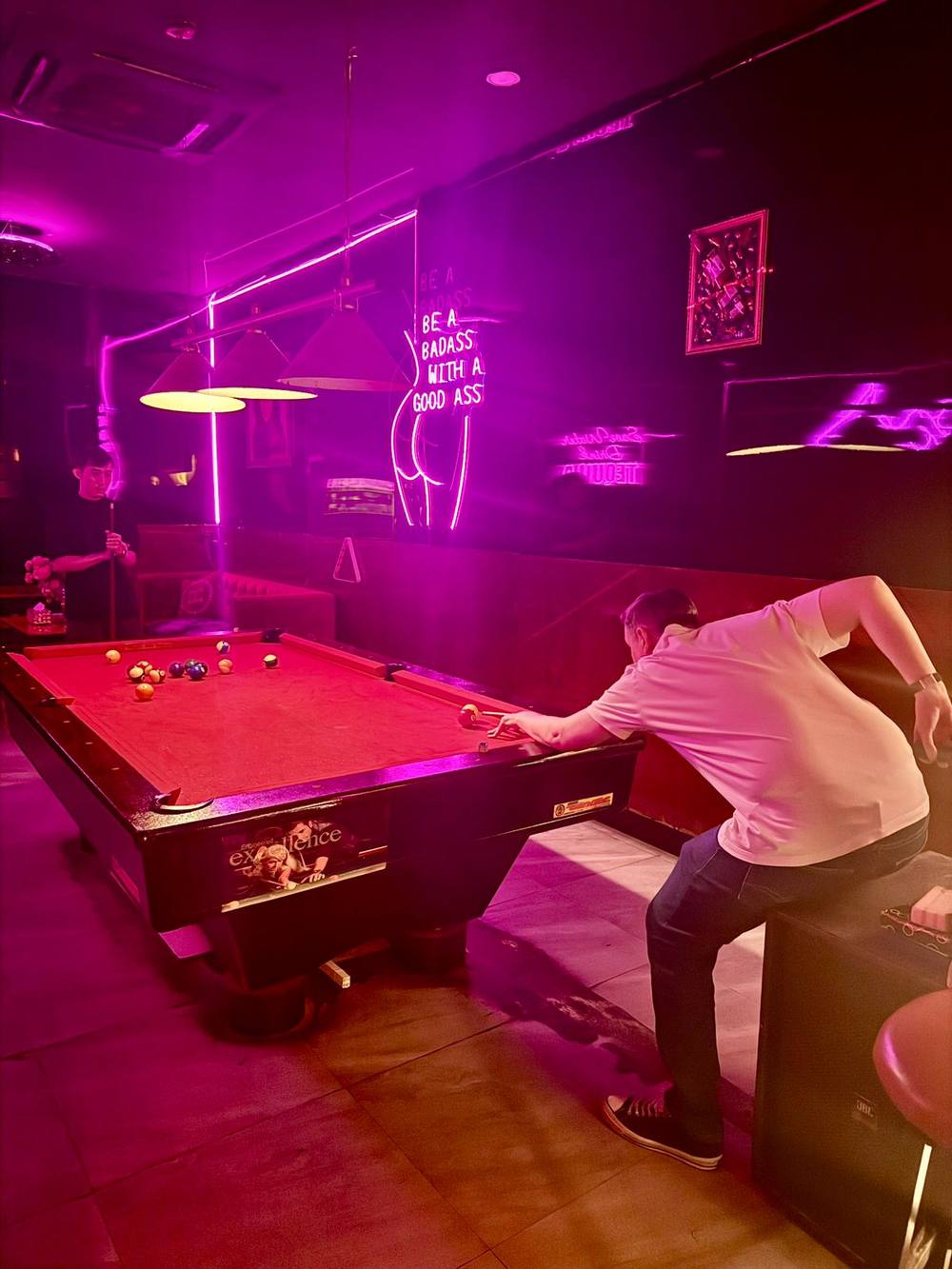 Guest taking a shot at the pool table, Honey Bar